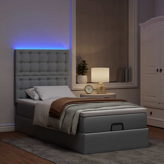 Ottoman bed met matras en LED's 90x200cm stof lichtgrijs